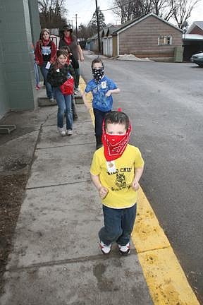 Nick Ianniello/Mineral Independent A group of Alberton students rush outside to try to rustle up some cattle during a scavenger hunt at the school's annual reading challenge celebration day.