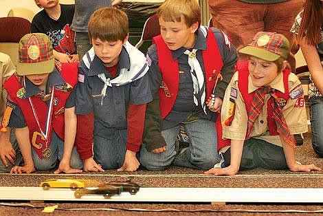 Photo by Ed Moreth Cub Scouts from Pack 46/57 watch as cars go by at the annual Pinewood Derby held at the LDS church in Plains. The Scouts from the left are: Douglas Damschen, Brian Baker, Josh Connolly and Spencer Lamb.