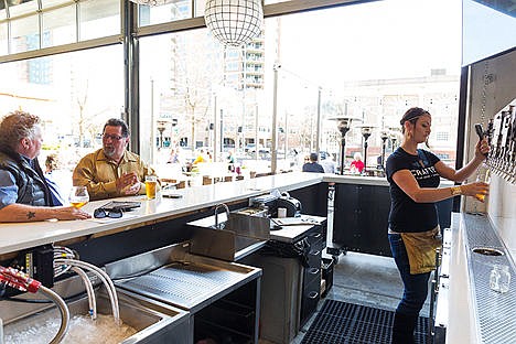 &lt;p&gt;Tricia Whitney, supervisor at Crafted Tap House and Kitchen, pours a beer during her shift Tuesday at the Coeur d&#146;Alene restaurant.&lt;/p&gt;