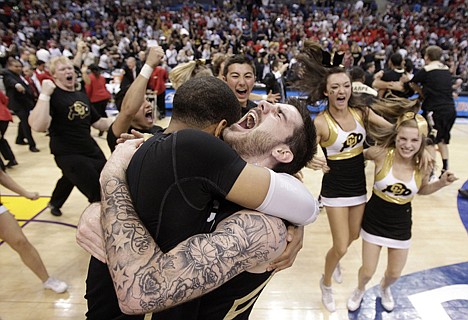 &lt;p&gt;Colorado's Nate Tomlinson, right, and teammate Carlon Brown celebrate their team's 53-51 win over Arizona in the Pac-12 tournament title game Saturday at Los Angeles.&lt;/p&gt;