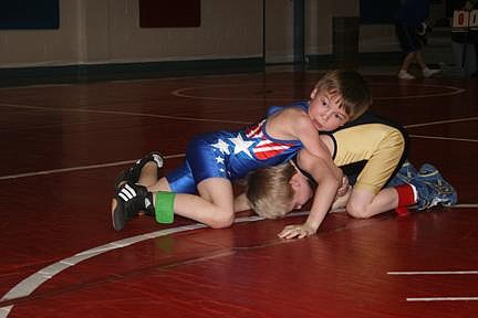 Nick Ianniello/Mineral Independent Superior Little Guy Bobcat Trenton Constante gets a hold on Thompson Falls Little Guy Hawk Mason Miller during a duel in Superior last Tuesday evening. Constante won the match 9-7 in overtime.
