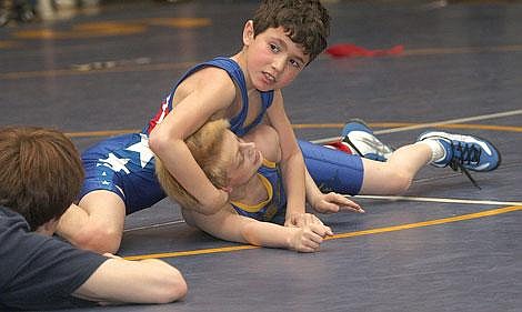 Photos by Aaric Bryan Nicholas Ververis looks toward his coach for instruction as he manhandles Libby&#146;s Chaz Judkins in the novice 55-pound class champion match at the Valley Tournament in Thompson Falls Saturday. Ververis pinned Judkins in under a minute. Ververis was one of nine Bobcats to finish in first place at the tournament.