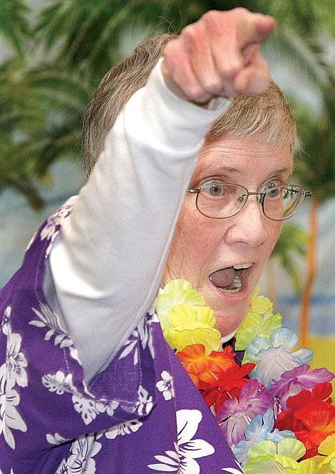 Photo by Ed Moreth &#147;Git &#145;er Done, fight back,&#148; shouts Sanders County Relay For Life chairperson at the Relay&#146;s kick-off ceremony Saturday evening. Miller and the group recited the slogan after several people read tips on cancer prevention.