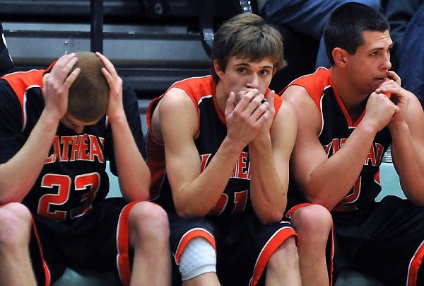 From left to right, Flathead players Ian Gillespie, Joe Pistorese, and Mike VanArendonk sit on the bench as the clock winds down toward the end of the game.