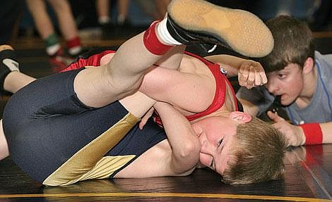 Photo by Ed Moreth Savage Horseman Russell Kujala holds his opponent, Dalton Hooten, a Thompson Falls Bluehawk, while referee Matt Hojem looks to see if Hooten&#146;s shoulders are on the mat. Kujala pinned Hooten in 1:08 and went on to place third in the novice 80-pound class at the Valley Tournament.