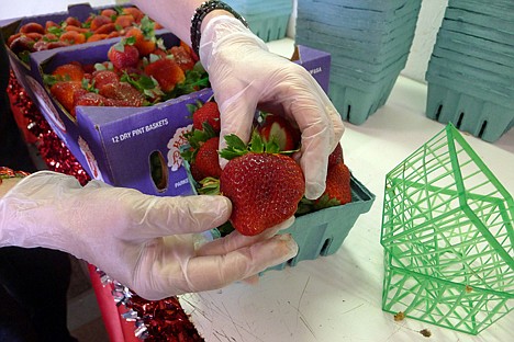 &lt;p&gt;Parke shows off a plump strawberry for sale at the Florida Strawberry Festival in Plant City, Fla. A warm winter in the Sunshine State has yielded a bumper crop of berries.&lt;/p&gt;