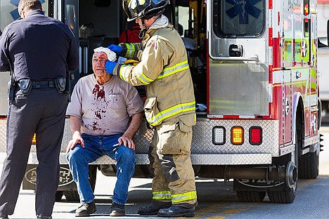 &lt;p&gt;Leonard Hammrich, 74, has his injuries treated by Coeur d&#146;Alene Fire Department firefighter Ryan Wing after being struck head-on by another vehicle on U.S. 95.&lt;/p&gt;