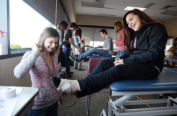 &lt;p&gt;Kaitlin Bradley, left, from Flathead High School and Janeese Brisbo from Glacier High School take part in a physical therapist assistant class Tuesday at Flathead Valley Community College in Kalispell. They were among nearly 700 area high school juniors who visited the college for the Sixth Annual College for a Day. Students had the opportunity to experience classes related to their chosen career paths.&lt;/p&gt;