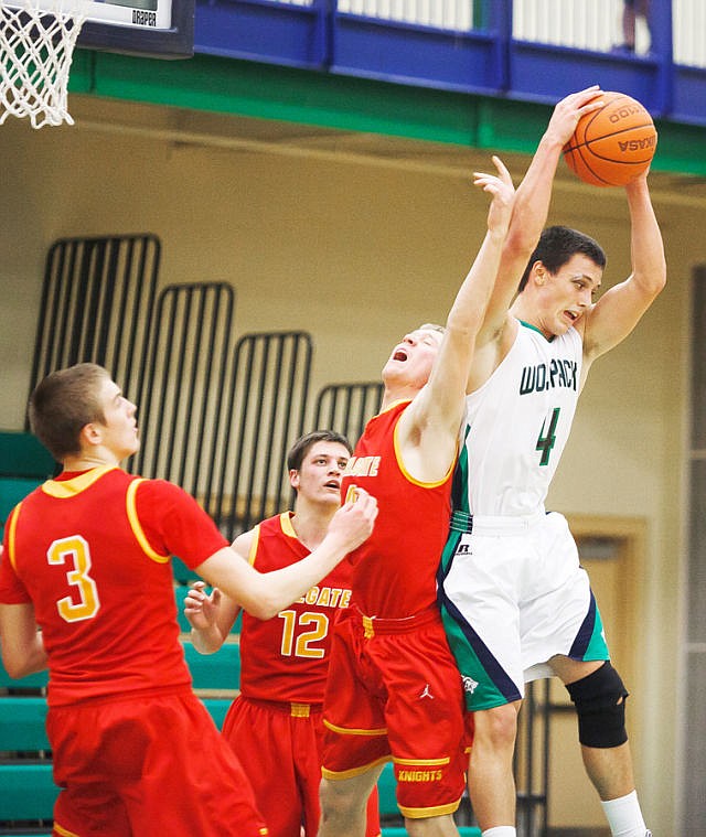<p>Glacier senior guard Kyle Griffith (4) pulls down a rebound Friday night during Glacier's home victory over Hellgate. Friday, Feb. 22, 2013 in Kalispell, Montana. (Patrick Cote/Daily Inter Lake)</p>