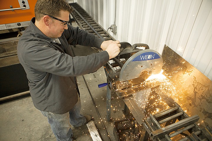 &lt;p&gt;Josh Boyce, co-owner of Acutech, cuts mild steel into short pieces to be used as support straps at the new Acutech building outside&#160; Columbia Falls on Tuesday.&lt;/p&gt;