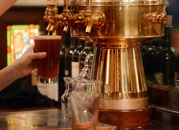 &lt;p&gt;A server pours a beer at the Split Rock Cafe March 7 in Kalispell.&lt;/p&gt;