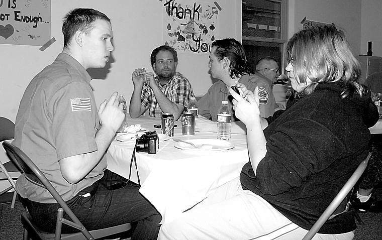 <p>Josh Matlock, Robert Kenyon and Katie Kenyon relax after their meal at the Superior Firefighter's appreciation dinner. </p>