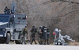 Homicide suspect surrenders after standoff