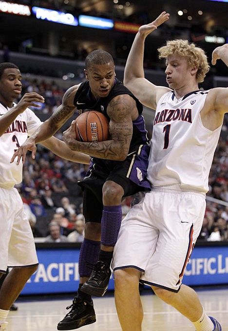 &lt;p&gt;Washington guard Isaiah Thomas, center, gets a rebound against Arizona center Kyryl Natyazhko (1) in the first half of the Pac-10 tournament championship game Saturday at Los Angeles.&lt;/p&gt;