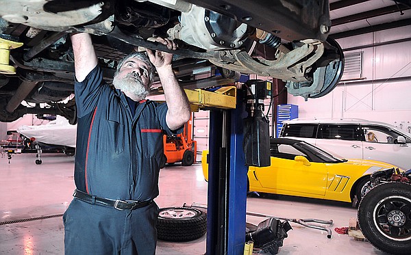 Auto Tech Gary Rackawak of Kila works on a truck in the Green Nissan service center on Wednesday morning in Evergreen.