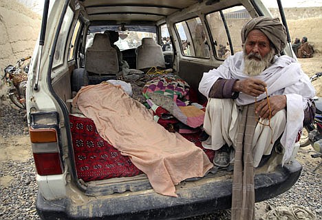 &lt;p&gt;An elderly Afghan man sits next to the covered body of a person who was allegedly killed by a U.S. service member, in a minibus in Panjwai, Kandahar province south of Kabul, Afghanistan, Sunday, March 11, 2012. A U.S. service member walked out of a base in southern Afghanistan before dawn Sunday and started shooting Afghan civilians, according to villagers and Afghan and NATO officials. Villagers showed an Associated Press photographer 15 bodies, including women and children, and alleged they were killed by the American. (AP Photo/Allauddin Khan)&lt;/p&gt;