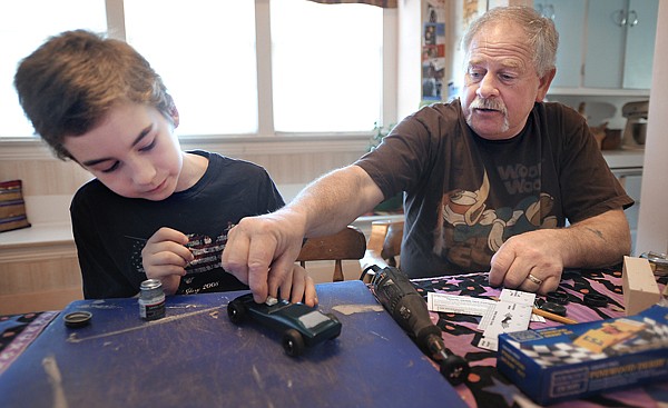 Samuel Vance, 9, and his grandfather Woody Woodruff, both of Kalispell, work on Vance's pinewood derby car on Saturday afternoon in Kalispell. Woodruff laughs has he watches his grandson focus on painting details on the car. &quot;A three dollar car ends up costing 30 dollars by the time your done with it,&quot; said Woodruff. The Boy Scouts Pinewood Derby will be held at the Kalispell Center mall on Saturday, March 20, beginning at 11 a.m.