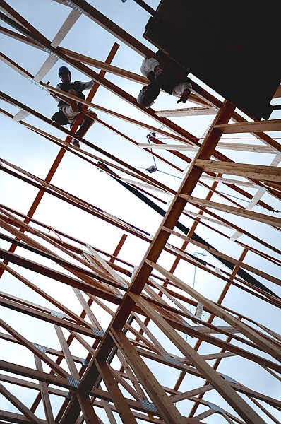 Tyler Collier, left, and Josh Allen, framers with Teal Brothers Construction, set trusses for the roof of the Montana Club restaurant and casino on Monday in Kalispell. &#147;It was a little bit slow going out of the ground but now we&#146;re speeding up,&#148; said Andrew Eisma, project superintendent for Martin Contracting. The roof should be finished by next week and the 8,000-square-foot building is expected to be completed in June.