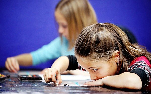 Haela Fierro, front, and Aryanna Deitrick, second graders at Cornelius Hedges School, draw pictures of Glacier National Park after touring the museum and looking at artwork that features the park on Tuesday at the Hockaday Museum.