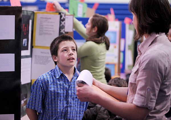 Trey Carmalt, a fifth grader at West Valley explains his project: As Fast As An Arrow to Amber Steed of Kalispell, a volunteer judge and a fish biologist for Fist, Wildlife, and Parks, at the Science Fair on Friday at West Valley School.