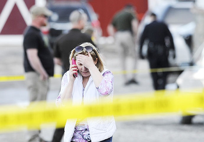 &lt;p&gt;&lt;strong&gt;A woman&lt;/strong&gt; who lives where two people were shot talks on the phone Friday evening as law officers investigate the incident southwest of Kalispell. A Missoula woman shot and injured her estranged husband from Kalispell, then shot and killed herself. (Aaric Bryan/Daily Inter Lake)&lt;/p&gt;