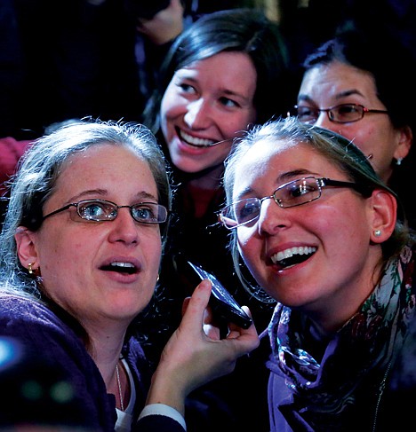 <p>Florencia Silva, left, from Peru, and Valentina Brunner, right, from Chile, listen to a cellphone live broadcast of the announcement of a new Pope on Wednesday as the Catholic faithfull gather at St. Patrick's Cathedral in New York. Argentine Jorge Bergoglio was elected pope Wednesday and chose the papal name Francis, becoming first pontiff from the Americas and the first from outside Europe in more than a millennium.</p>