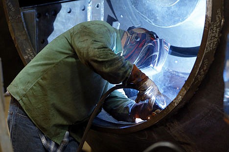 &lt;p&gt;A man welds parts in fans for industrial ventilation systems at the Robinson Fans Inc. plant in Harmony, Pa., on Feb. 12.&#160;&lt;/p&gt;