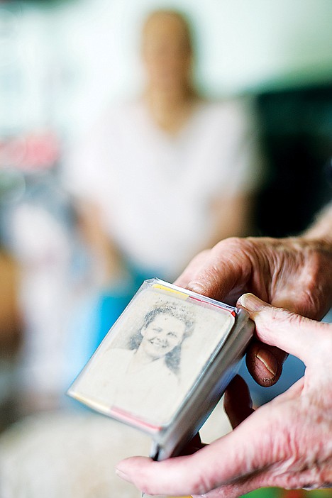 <p>Roy Wargi flashes the photo of his wife Vivian that he has kept in his wallet since being in the military decades ago.</p>