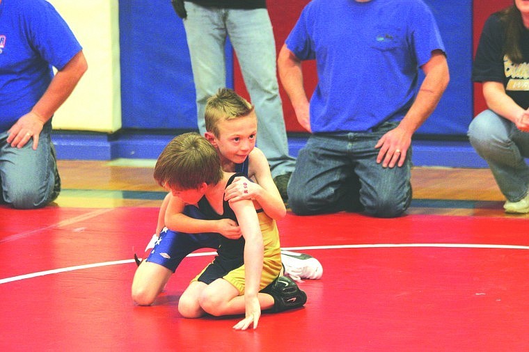 Dominic Savage works carefully to keep his opponent under control during a home meet.