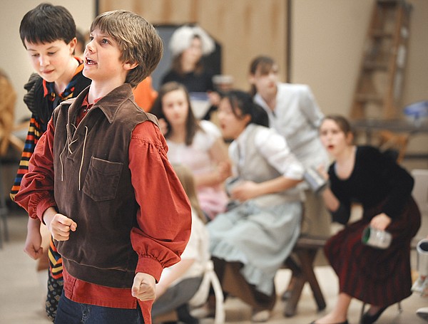 Eric West, in red, and James Early, left, as Gaston and LeFou rehearse a scene from Beauty and the Beast on Wednesday at Kalispell Junior High. The show opens Thursday, March 18.