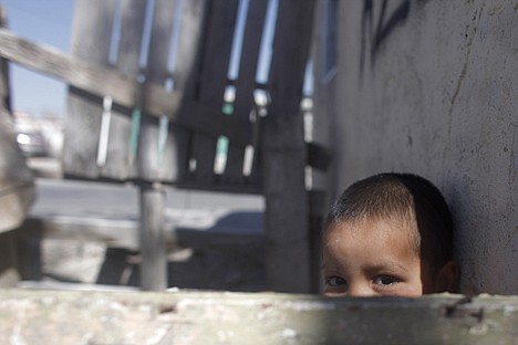 &lt;p&gt;A child peers from behind a fence outside his home on the outskirts of Ciudad Juarez, Mexico, Wednesday, March 17, 2010. The violence has risen to such levels in Ciudad Juarez that everyone feels at risk in the city of 1.3 million, where innocent people have been increasingly caught in the crossfire. (AP Photo/Miguel Tovar)&lt;/p&gt;