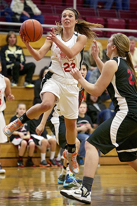 <p>North Idaho All Star Brooke Litalien, from Post Falls High, goes up for a shot against Elizabeth Landreth from Capital High.</p>