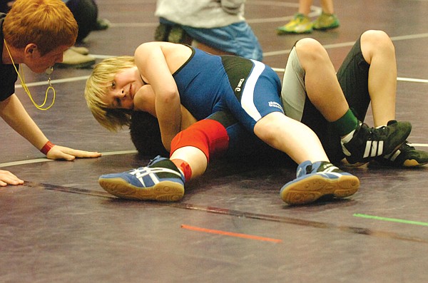 Mission's Bridger Smith pins Polson's Dillon Brooks in the middle 100 class. Smith finished first and Brooks finished third.