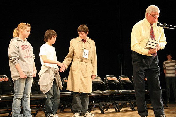 Ronan middle school principal Jim Gilhouse announces the awards for the top-three finishers at the 2010 Lake County Spelling Bee last Thursday. From left to right: 3rd place, Timber Munson, 8th grade, Charlo; 2nd Gabriel Azure, 8th grade, Ronan; 1st place, Cody Baer, 8th grade, Polson.