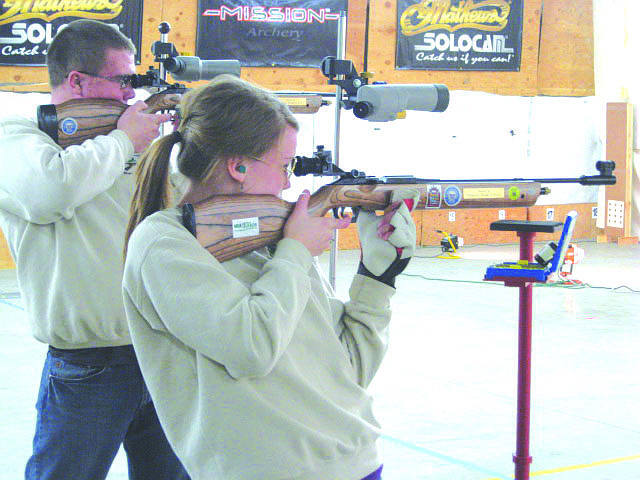 Dahkota Hayes and McKenzie Crabb take their shots during a tournament as they shoot from the standing position.