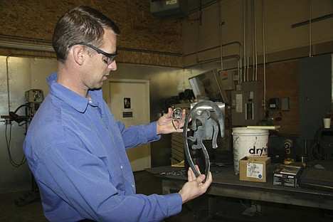 &lt;p&gt;Shannon Horn shows a small metal sculpture that was reproduced on a larger scale using River City Fabrication's computer-aided design system.&lt;/p&gt;