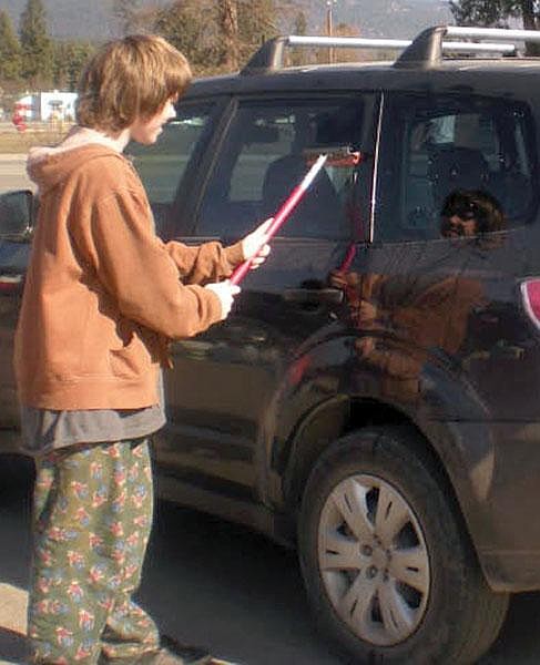 Courtesy Ollie Olson, a freshman at Libby High School, washes a vehicle window for a donation in the fight against famine.