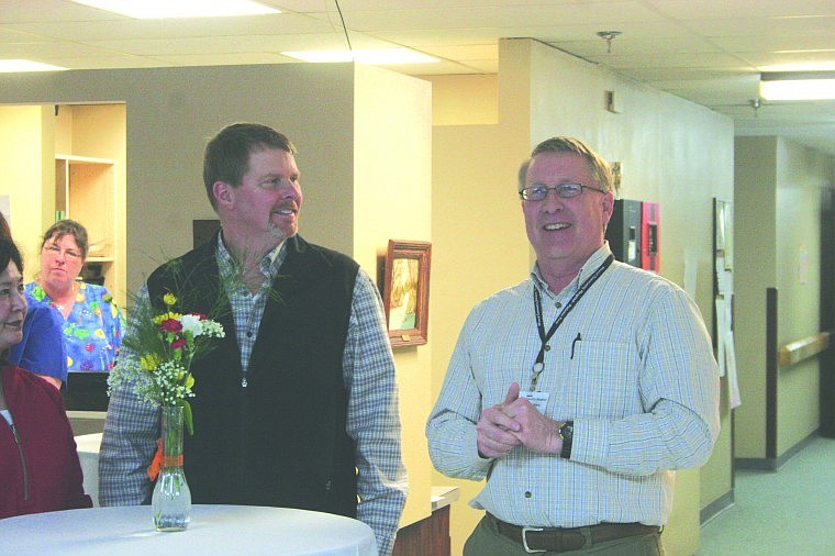 Hospital adminstrator Steve Carty (right) introduces Dr. Alan Alyea to the guests at an open house event last week. Alyea practices orthopedics.