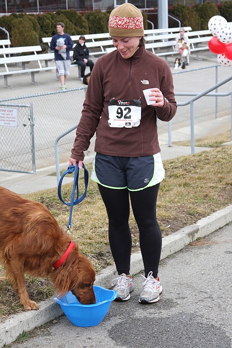 <p>Lauren Cuvala and Logan relax after the race at the Greyhound Park and Event Center.</p>