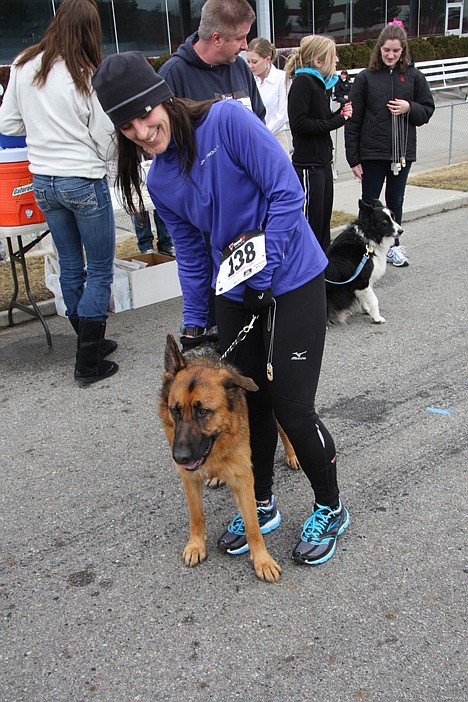 <p>Karin Walker of Rathdrum congratulates Sadie after finishing the Leashes and Laces 5K.</p>