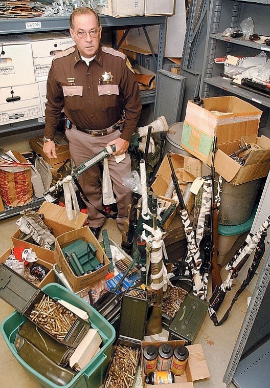 &lt;p&gt;In 2004, Sheriff Jim Dupont posed with a cache of weapons seized after the arrest of fugitive David Burgert.&lt;/p&gt;