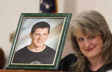 Photo by Aaric Bryan A picture of Brad Williams, who was struck and killed by Daniel Resler while he was driving drunk March 3, sits in front of District Judge Kim Christopher. The photograph was placed there by Williams' mother Carla Hayek just before she took the witness stand.