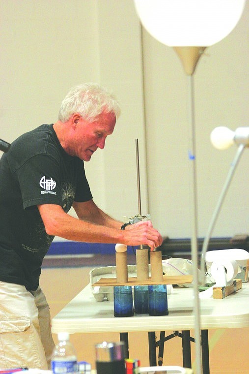 Glenn Govertsen &quot;Mr. G&quot; sets up an experiment with eggs, toilet paper rolls and three glasses of water.