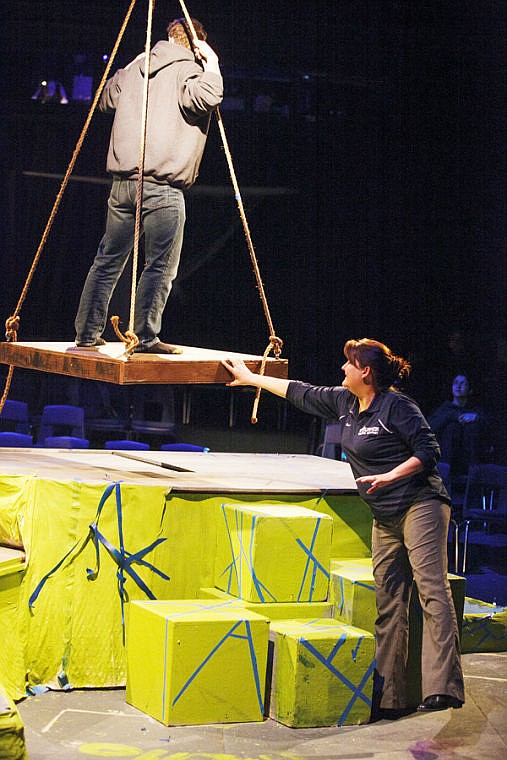<p>Director Ivanna Fritz, right, stabilizes a platform for senior Taylor Hulslander during a rehearsal for "Tarzan" at Glacier High School. </p>