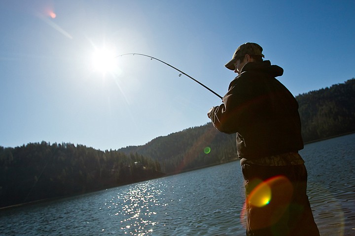 &lt;p&gt;Nick Moos reels in a fish from the shoreline of Fernan Lake as the sun shines down on him Friday morning.&lt;/p&gt;