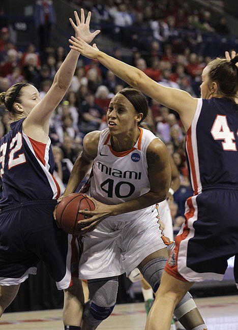 &lt;p&gt;Miami's Shawnice Wilson (40) tries to move between Gonzaga's Kayla Standish, left, and Kelly Bowen in the first half of an NCAA tournament second-round women's college basketball game in Spokane, Wash., Monday, March 19, 2012. (AP Photo/Elaine Thompson)&lt;/p&gt;