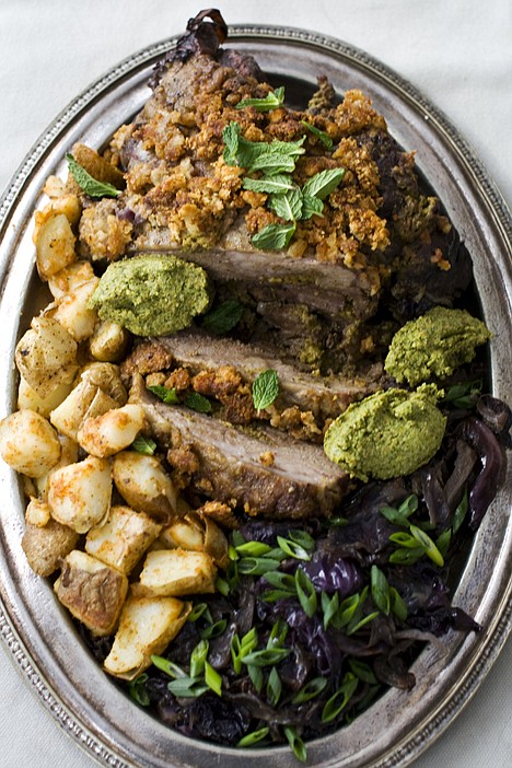<p>Orange and mint-stuffed lamb with sweet-and-sour cabbage is shown served on a plate.</p>