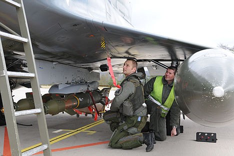 &lt;p&gt;French soldiers inspect a GBU.12 bomb on a French Mirage 2000 jet fighter at the military base of Nancy, eastern France, Saturday. Immediate military action was launched to protect civilians as Libyan leader Moammar Gadhafi's forces attacked the heart of the country's rebel uprising.&lt;/p&gt;