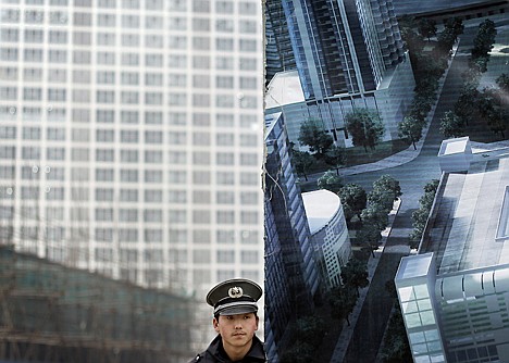 &lt;p&gt;A security guard stands watch outside a buildings construction site in Beijing Thursday, March 18, 2010. The World Bank raised its China growth forecast this year to 9.5 percent from 9 percent on Wednesday but said Beijing needs to cool inflation and possible bubbles in real estate prices. (AP Photo/Andy Wong)&lt;/p&gt;