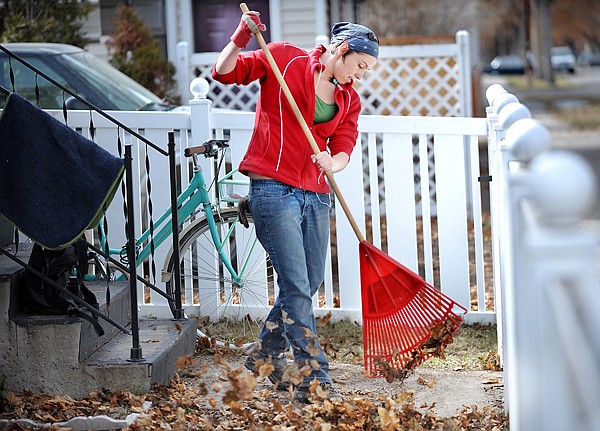 Cara Webb of Kalispell rakes leaves up in her yard on Wednesday in Kalispell.